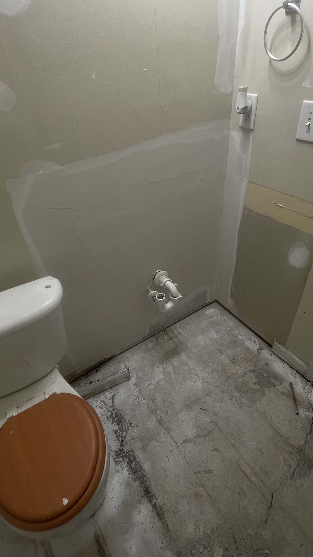 Wide mudding pass on bathroom wall behind vanity plumbing
